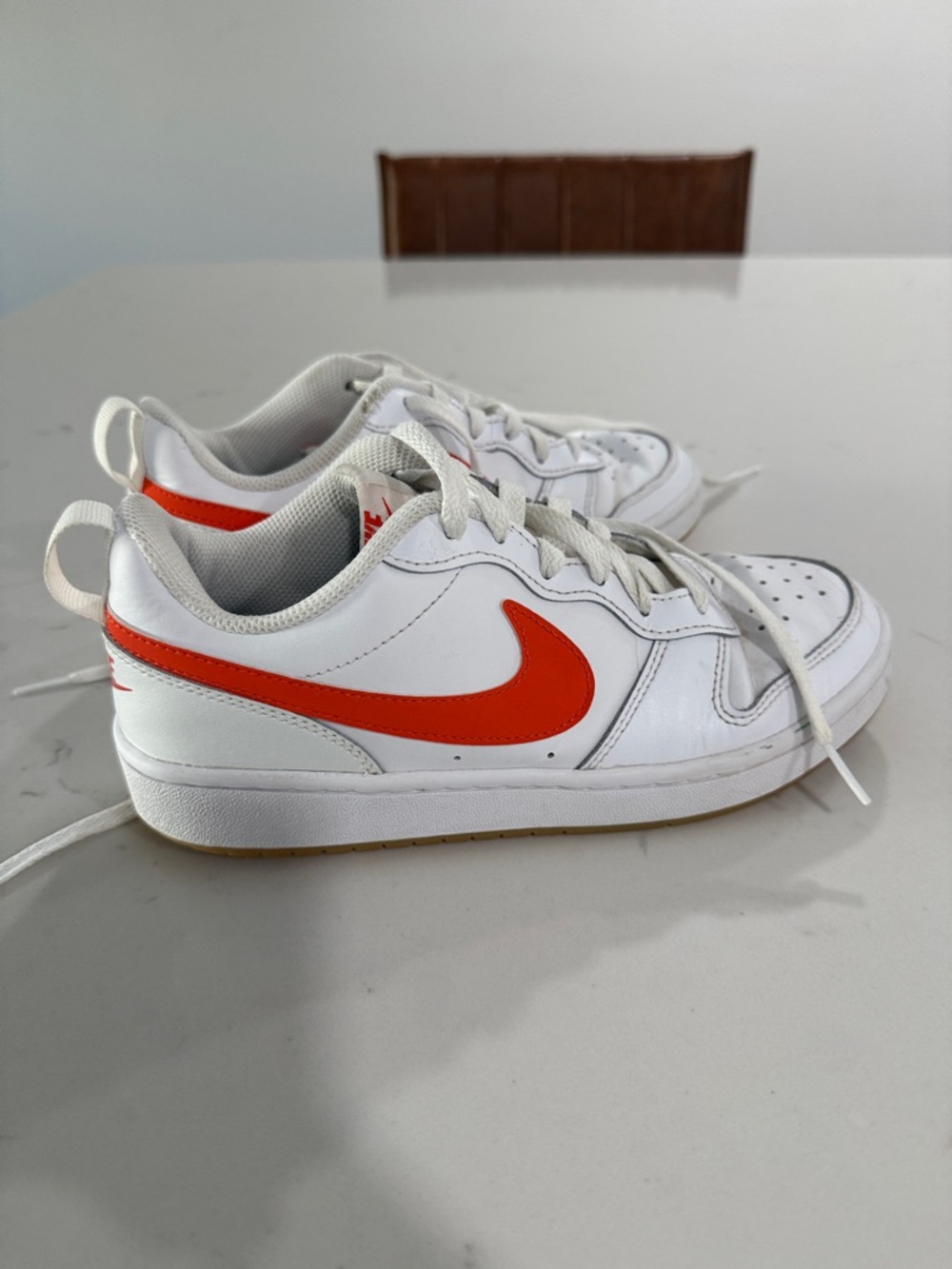 Nike Kids White Sneakers with Bright Orange Swoosh